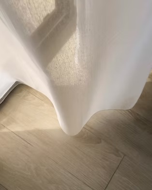 White sheer curtain in sunlight